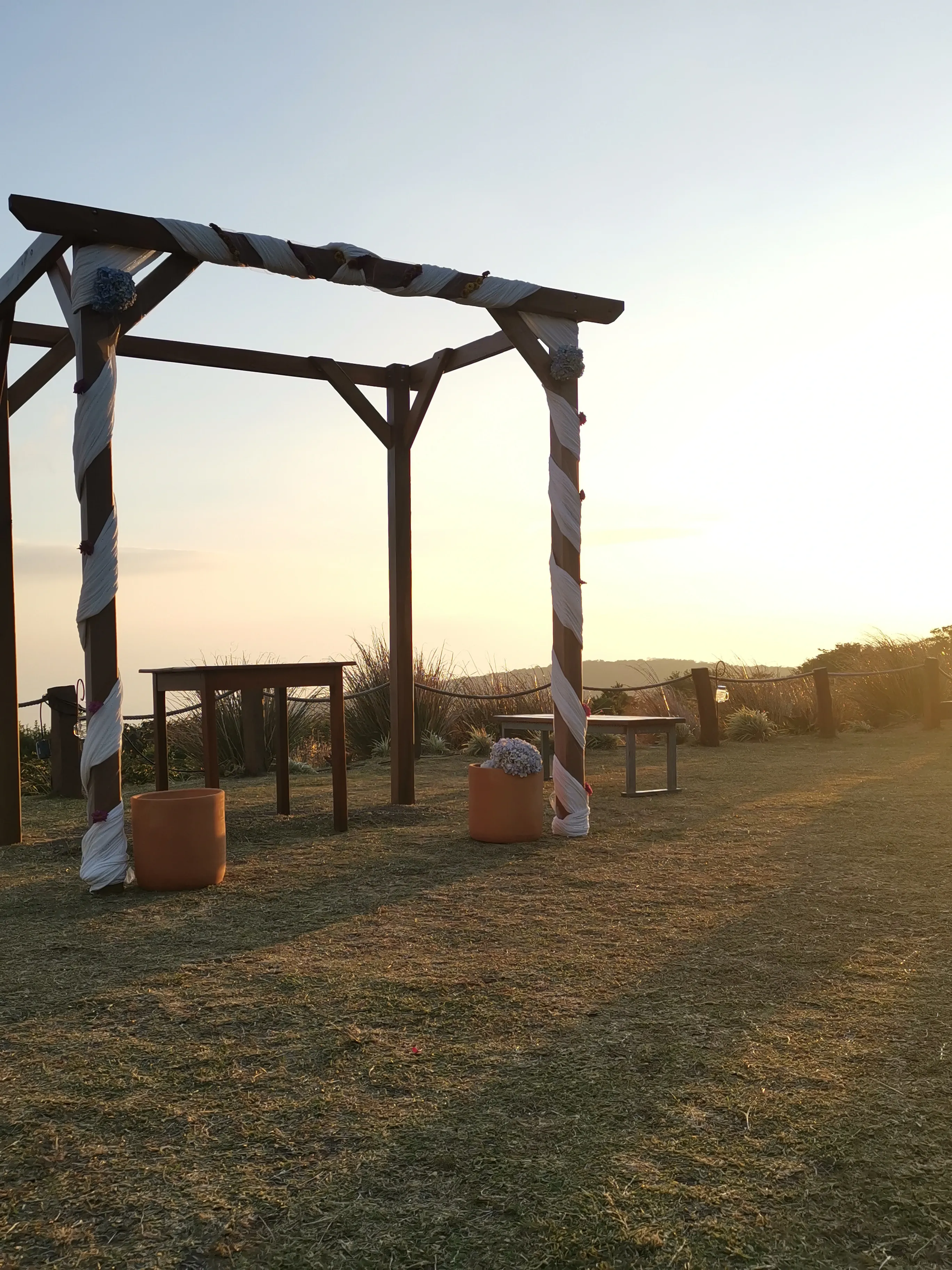 Here is a look at one of our wedding ceremony location options. This one is in front of Valle Escondido during a sunset. Beautiful mountain views are beyond where the bride and groom will get married.