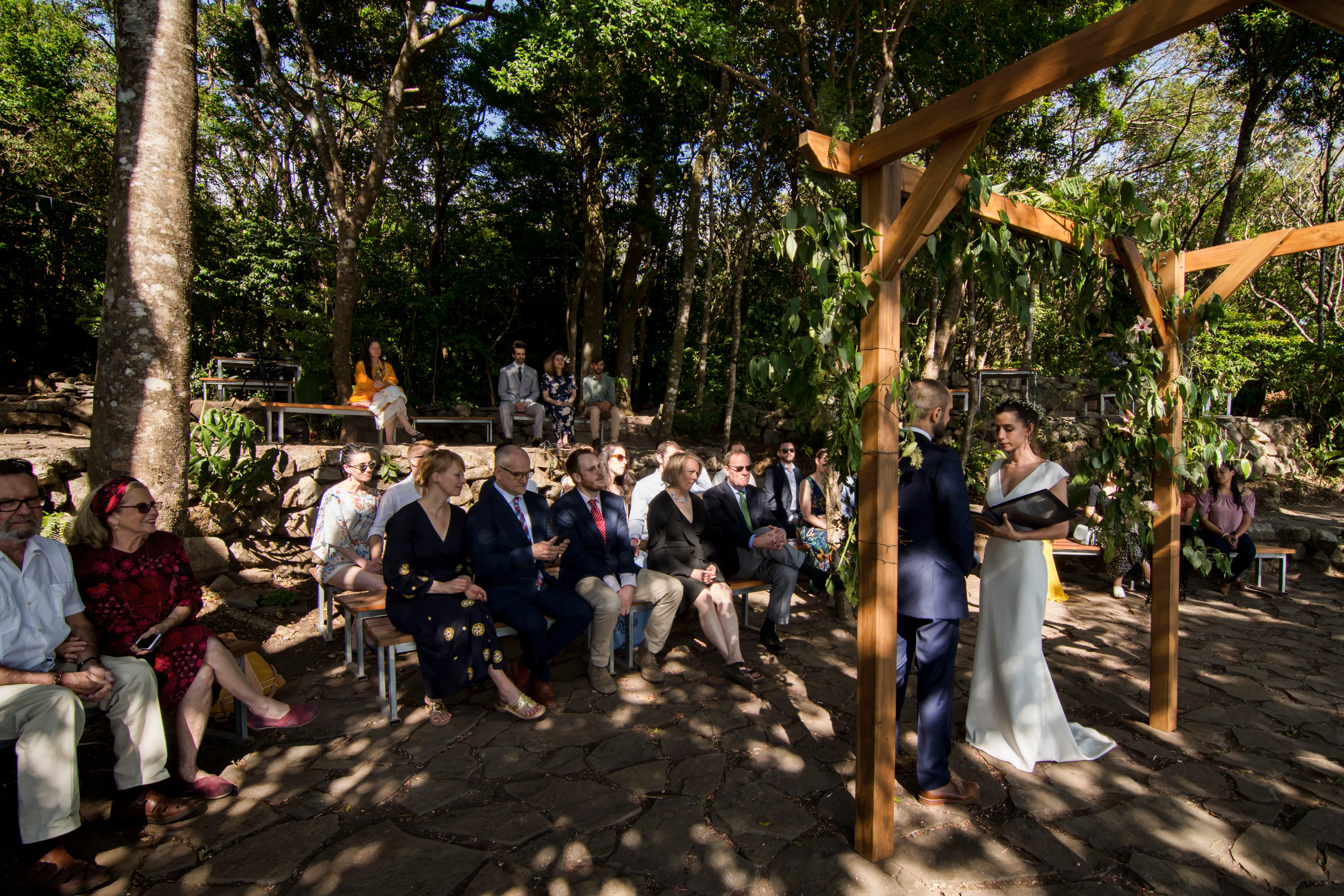 Visitors and guests gather for the bride and groom to say their vows at their wedding in the picnic area of Valle Escondido.