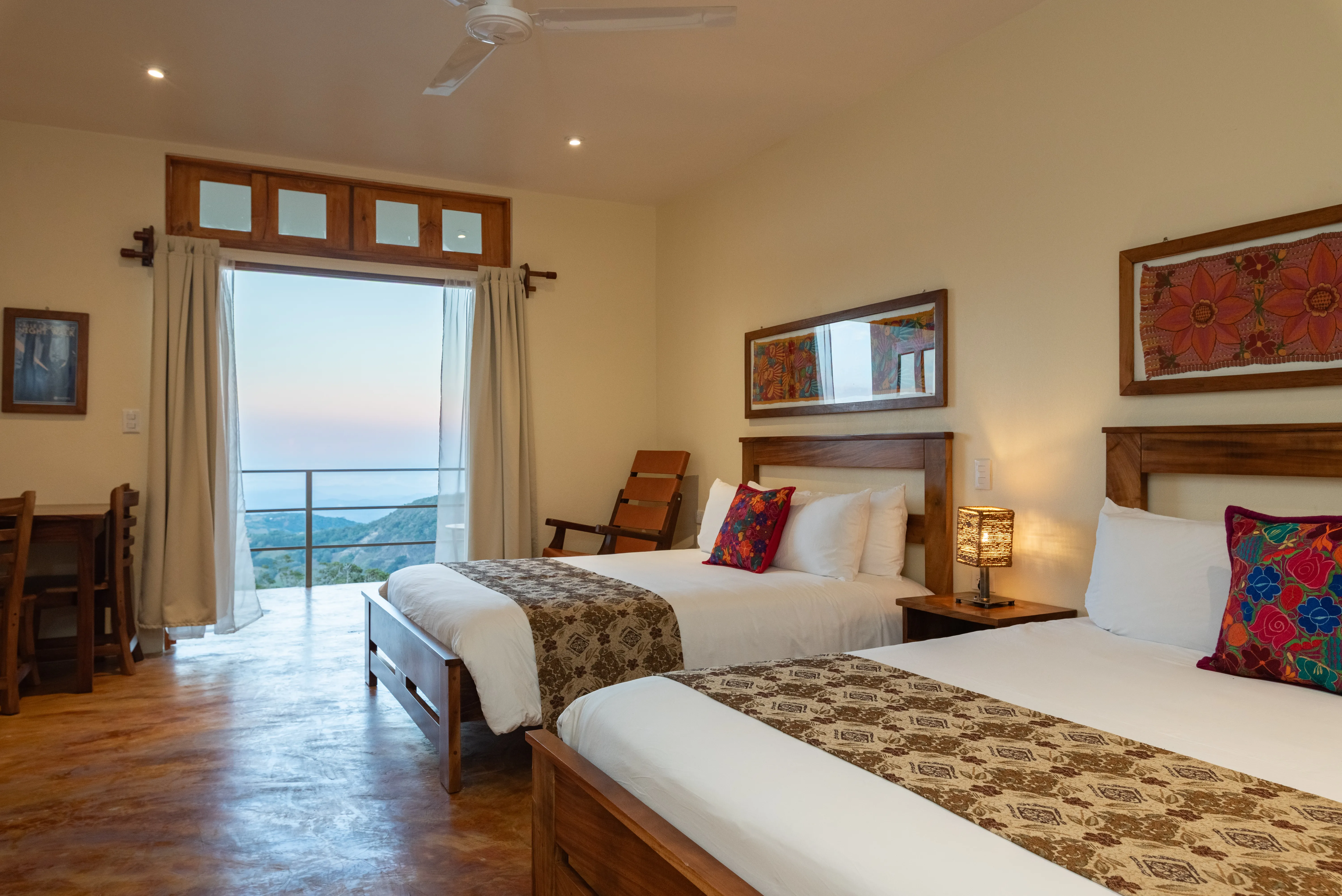 Room with two beds and an open balcony with a view