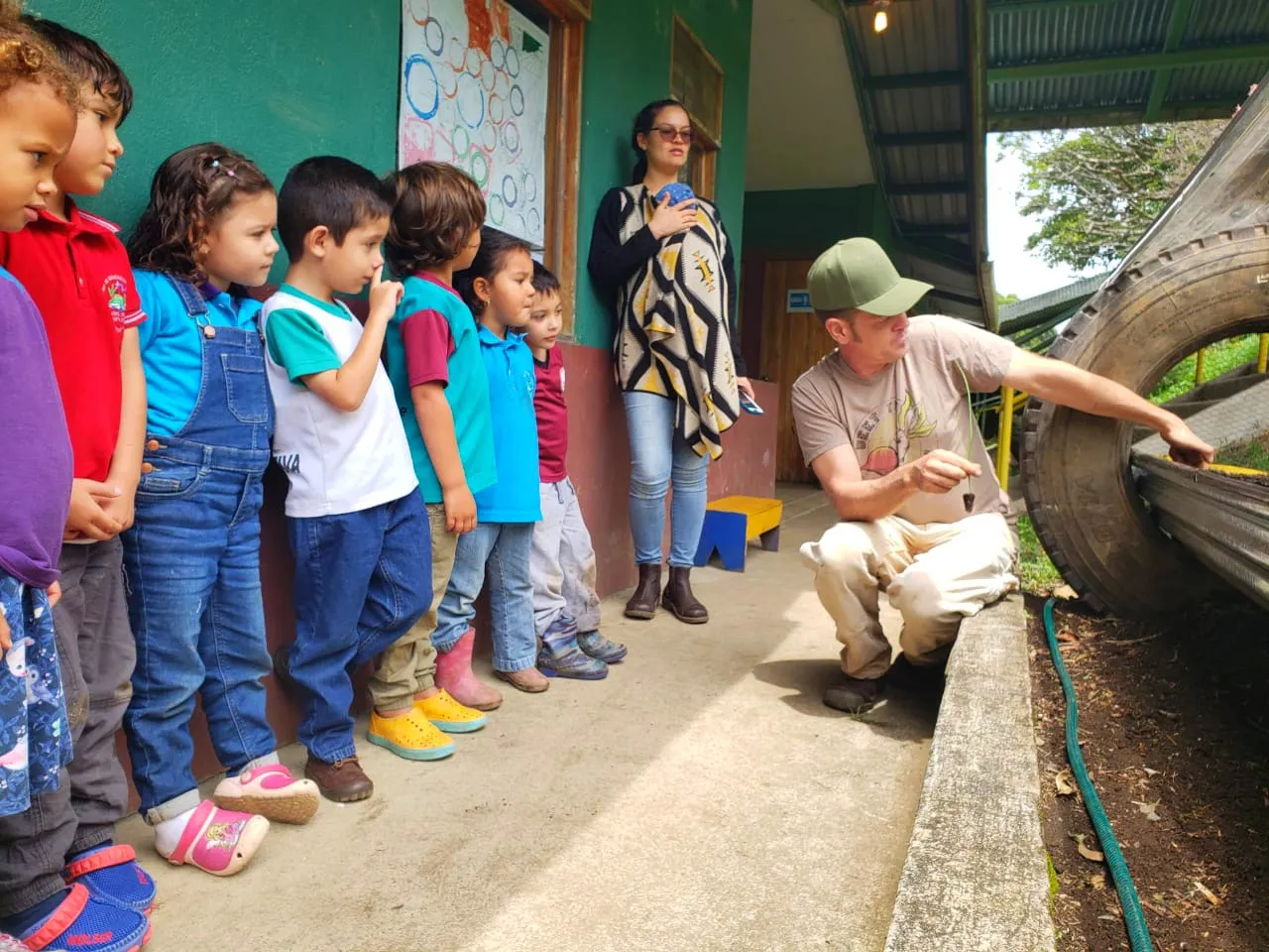 Valle Escondido's owner, Jonah, teaches kids about permaculture through our greenhouses.